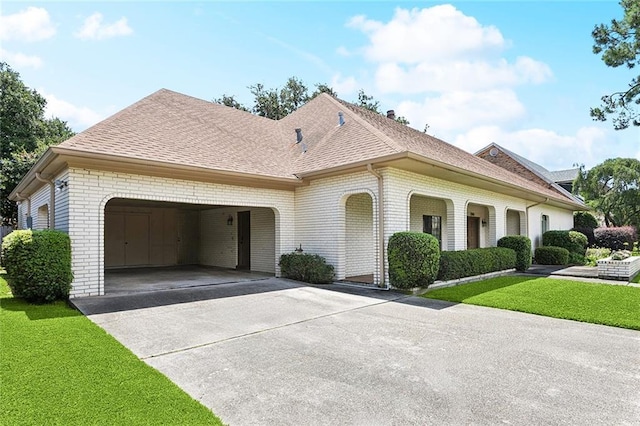 3709 Metairie Hts, Metairie, LA 70002 - view of front of property featuring brick siding, an attached garage, driveway, a shingled roof, and a front lawn
