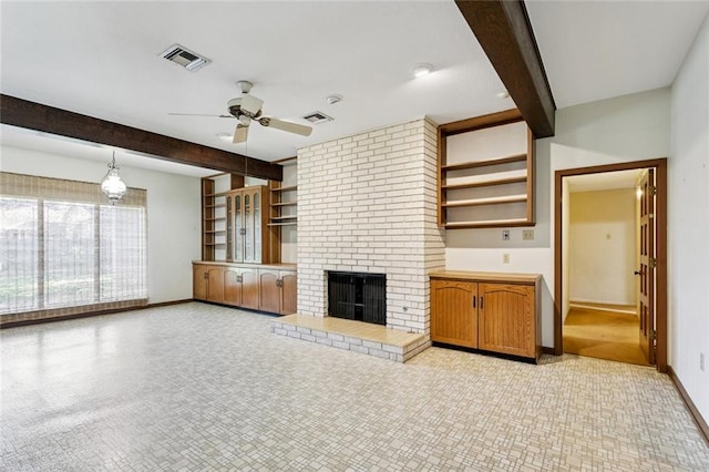 3709 Metairie Hts, Metairie, LA 70002 - unfurnished living room featuring beamed ceiling, ceiling fan, and a brick fireplace