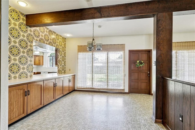 3709 Metairie Hts, Metairie, LA 70002 - kitchen with a chandelier, light countertops, beam ceiling, hanging light fixtures, and brown cabinets