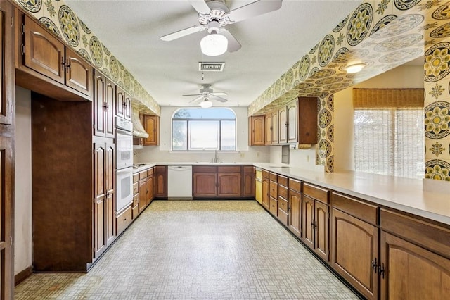 3709 Metairie Hts, Metairie, LA 70002 - kitchen featuring white appliances, ceiling fan, light countertops, light flooring, and brown cabinets