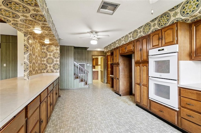 3709 Metairie Hts, Metairie, LA 70002 - kitchen featuring white double oven, ceiling fan, wallpapered walls, light countertops, and light floors