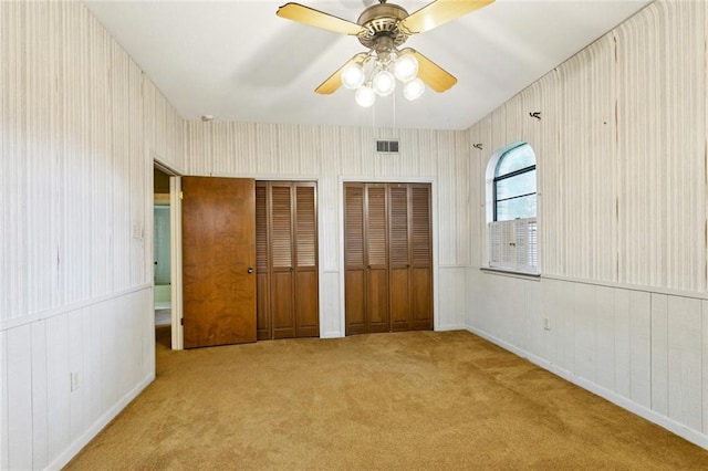 3709 Metairie Hts, Metairie, LA 70002 - unfurnished bedroom featuring two closets, carpet floors, and ceiling fan