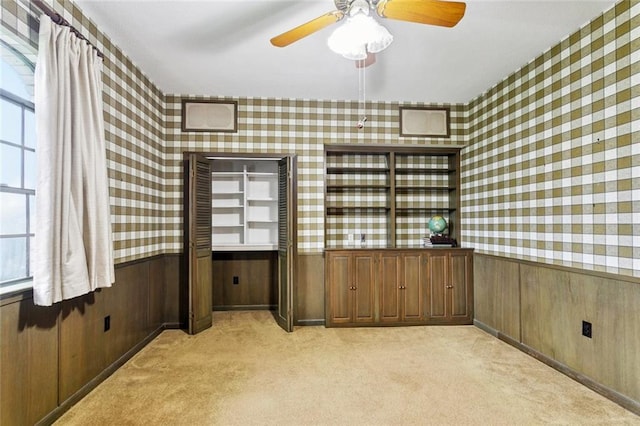 3709 Metairie Hts, Metairie, LA 70002 - spare room featuring wallpapered walls, light colored carpet, wainscoting, wood walls, and a ceiling fan