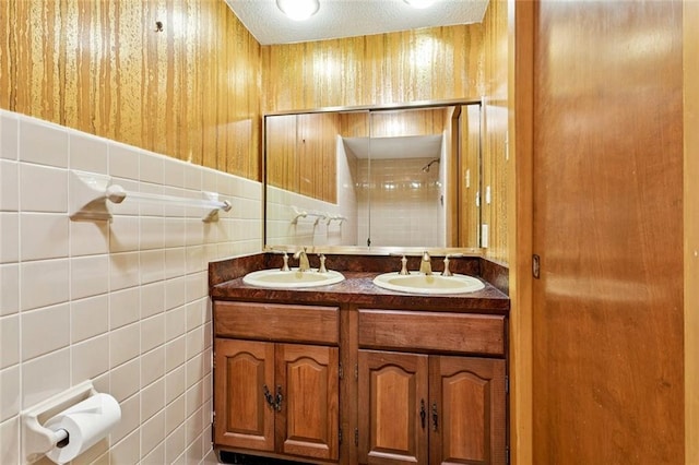 3709 Metairie Hts, Metairie, LA 70002 - full bath featuring tile walls, double vanity, and a textured ceiling