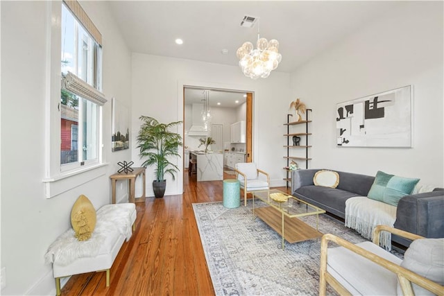 3311 Saint Ann St, New Orleans, LA 70119 - living room featuring a chandelier, wood finished floors, and recessed lighting