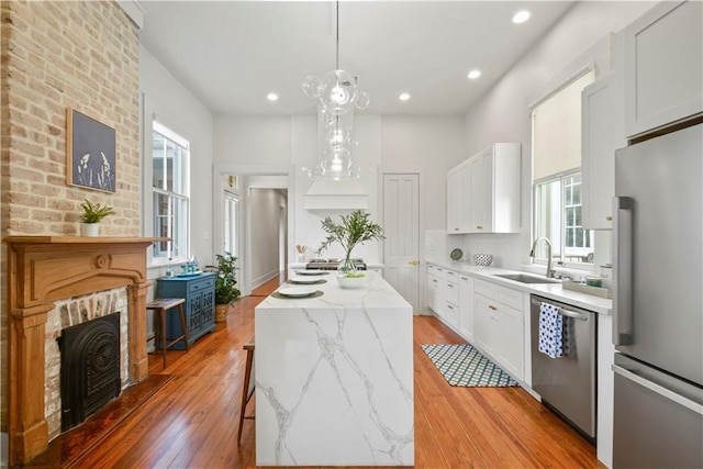 3311 Saint Ann St, New Orleans, LA 70119 - kitchen featuring stainless steel appliances, a kitchen island, healthy amount of natural light, white cabinets, and recessed lighting