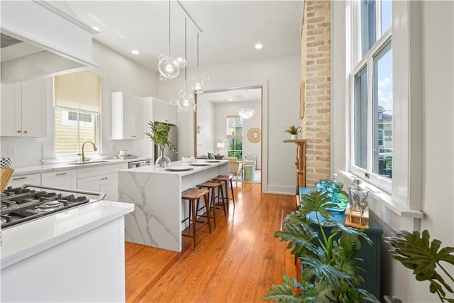 3311 Saint Ann St, New Orleans, LA 70119 - kitchen featuring a kitchen island, plenty of natural light, a kitchen bar, and recessed lighting