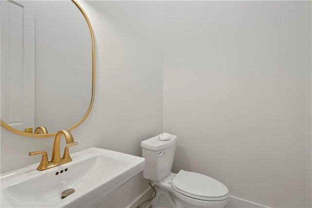 3311 Saint Ann St, New Orleans, LA 70119 - half bathroom with a sink and baseboards