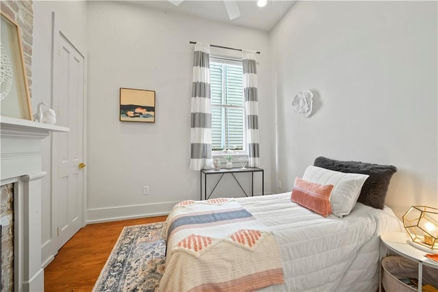 3311 Saint Ann St, New Orleans, LA 70119 - bedroom featuring wood finished floors and a fireplace