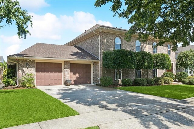 5033 Bissonet Dr, Metairie, LA 70003 - view of front of home featuring an attached garage, a front yard, driveway, and brick siding