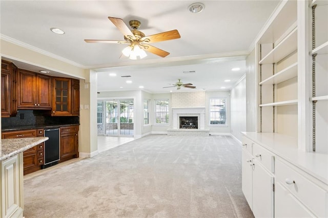 5033 Bissonet Dr, Metairie, LA 70003 - unfurnished living room with ornamental molding, light colored carpet, ceiling fan, a brick fireplace, and recessed lighting