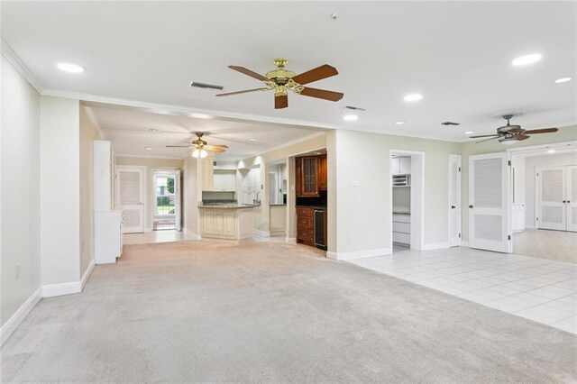 5033 Bissonet Dr, Metairie, LA 70003 - unfurnished living room featuring crown molding, light carpet, ceiling fan, recessed lighting, and light tile patterned floors