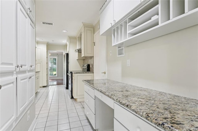 5033 Bissonet Dr, Metairie, LA 70003 - kitchen featuring light tile patterned flooring, stainless steel range with electric stovetop, light stone counters, recessed lighting, and built in study area