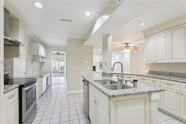 5033 Bissonet Dr, Metairie, LA 70003 - kitchen featuring appliances with stainless steel finishes, ceiling fan, light tile patterned flooring, wall chimney exhaust hood, and crown molding