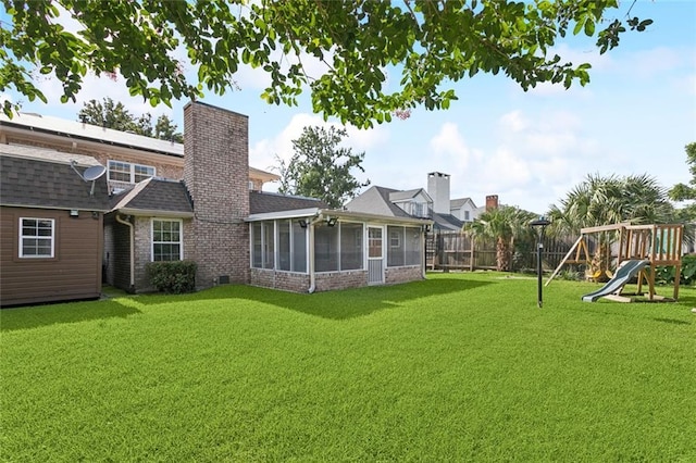 5033 Bissonet Dr, Metairie, LA 70003 - fenced backyard with a sunroom and a playground