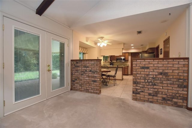 1005 Oakland Dr, Pearl River, LA 70452 - living area with light carpet, ceiling fan, french doors, light tile patterned floors, and vaulted ceiling