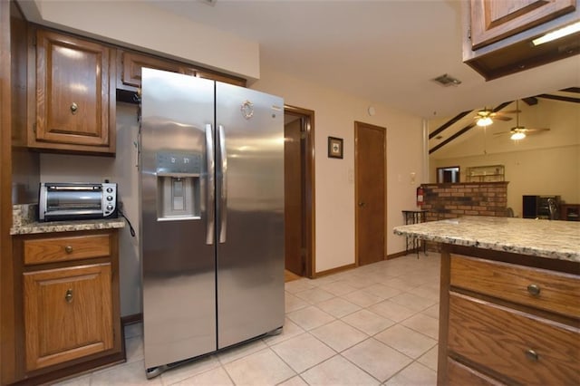 1005 Oakland Dr, Pearl River, LA 70452 - kitchen featuring stainless steel fridge with ice dispenser, light tile patterned floors, ceiling fan, and brown cabinetry