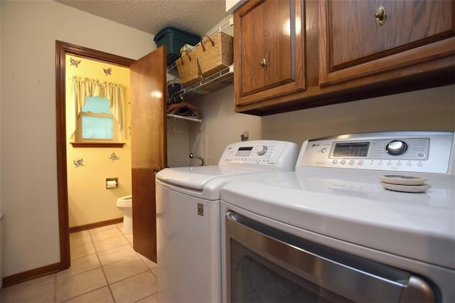 1005 Oakland Dr, Pearl River, LA 70452 - washroom with washer and dryer, light tile patterned floors, cabinet space, and a textured ceiling