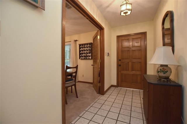 1005 Oakland Dr, Pearl River, LA 70452 - foyer with light colored carpet and light tile patterned floors