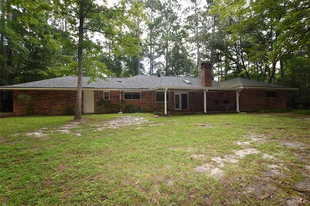 1005 Oakland Dr, Pearl River, LA 70452 - rear view of house featuring a chimney, a yard, and brick siding