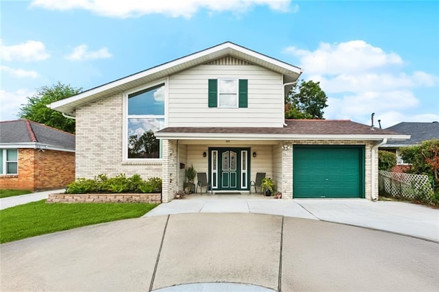 822 Homestead Ave, Metairie, LA 70005 - view of front of house with driveway, a garage, and brick siding