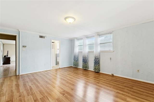 822 Homestead Ave, Metairie, LA 70005 - spare room featuring light wood-style flooring and ornamental molding