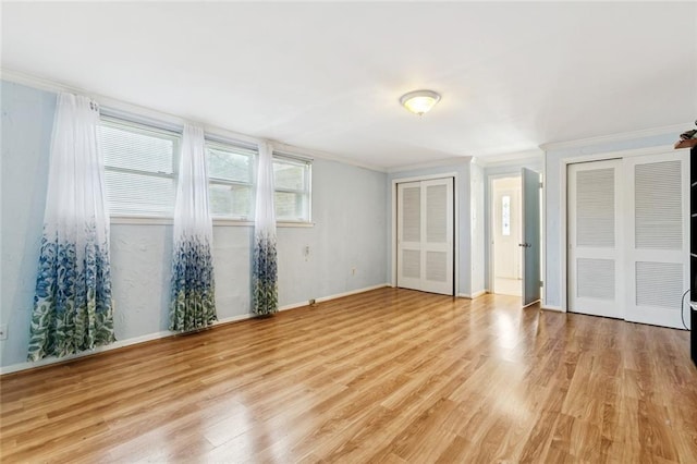822 Homestead Ave, Metairie, LA 70005 - unfurnished bedroom featuring crown molding, two closets, and light wood-style floors