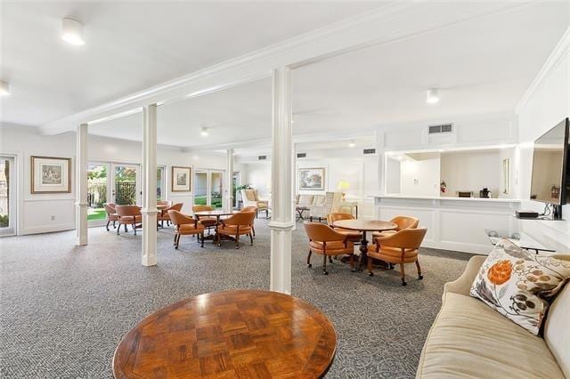 800 Rue Burgundy St Unit 223, Metairie, LA 70005 - carpeted living room featuring decorative columns and crown molding