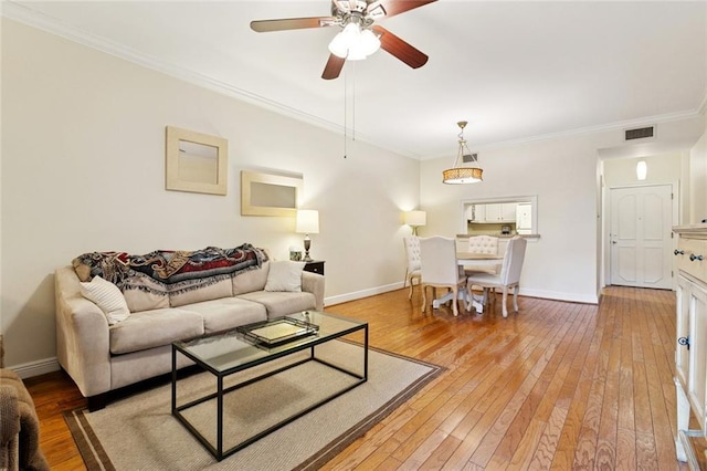 800 Rue Burgundy St Unit 223, Metairie, LA 70005 - living room with light wood-style floors, ceiling fan, and ornamental molding
