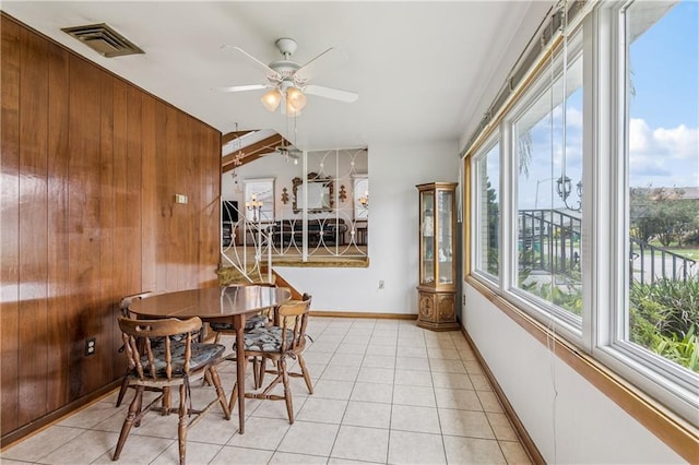 6213 Rosalie Ct, Metairie, LA 70003 - dining room with ceiling fan, wooden walls, and light tile patterned floors