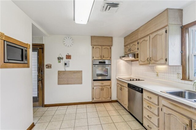 6213 Rosalie Ct, Metairie, LA 70003 - kitchen featuring stainless steel appliances, light countertops, and light brown cabinets
