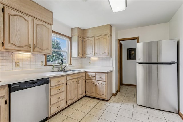 6213 Rosalie Ct, Metairie, LA 70003 - kitchen with stainless steel appliances, light brown cabinets, backsplash, and light countertops