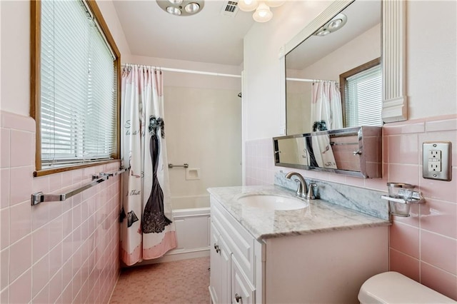 6213 Rosalie Ct, Metairie, LA 70003 - bathroom with tile walls, vanity, shower / bath combination with curtain, wainscoting, and tile patterned flooring
