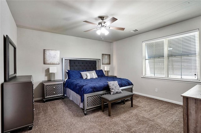 801 Lakeshore Village Dr, Slidell, LA 70461 - bedroom with dark colored carpet and ceiling fan