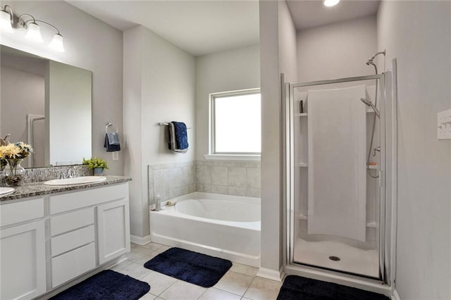 801 Lakeshore Village Dr, Slidell, LA 70461 - full bathroom featuring a stall shower, a garden tub, double vanity, and tile patterned floors