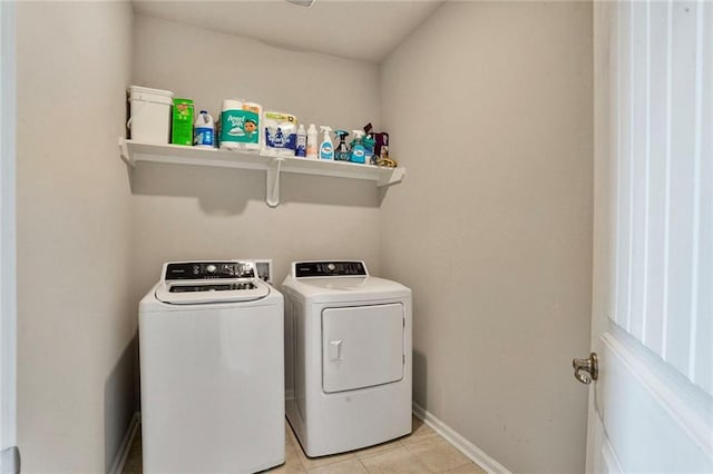 801 Lakeshore Village Dr, Slidell, LA 70461 - laundry room with washer and dryer and light tile patterned floors