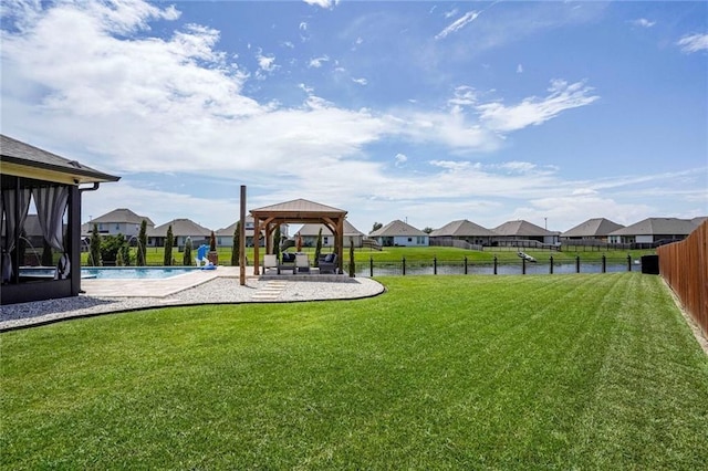 801 Lakeshore Village Dr, Slidell, LA 70461 - fenced backyard featuring a gazebo, a residential view, a patio, and a sunroom