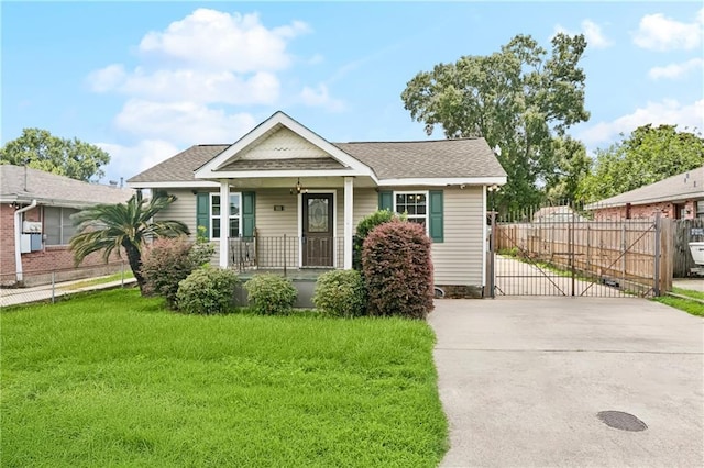 501 Oriole St, Metairie, LA 70006 - bungalow featuring a gate, covered porch, concrete driveway, and roof with shingles
