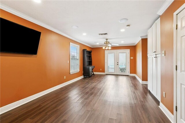 501 Oriole St, Metairie, LA 70006 - unfurnished living room with a wood stove, dark wood-style floors, french doors, crown molding, and ceiling fan