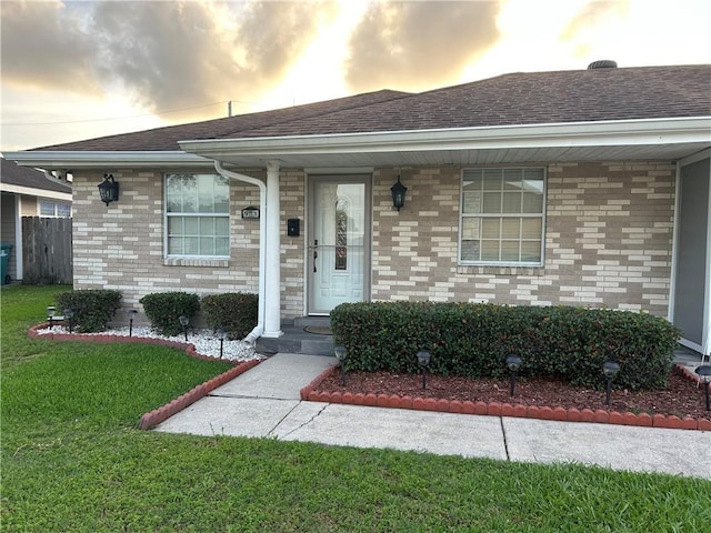 532 Deerfield Rd, Terrytown, LA 70056 - view of front of home with a front lawn, a shingled roof, and brick siding