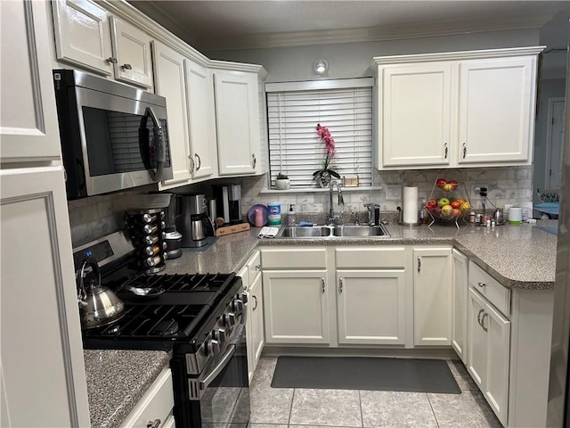532 Deerfield Rd, Terrytown, LA 70056 - kitchen with appliances with stainless steel finishes, crown molding, decorative backsplash, and white cabinetry