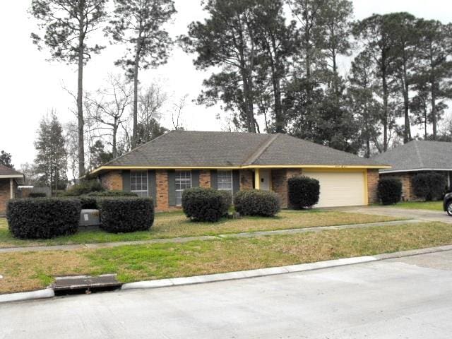 1411 Patriot St, Slidell, LA 70458 - single story home featuring concrete driveway, an attached garage, a front lawn, and brick siding