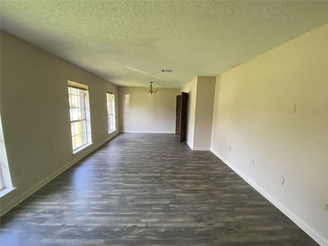 1411 Patriot St, Slidell, LA 70458 - spare room featuring a chandelier, a textured ceiling, and dark wood finished floors