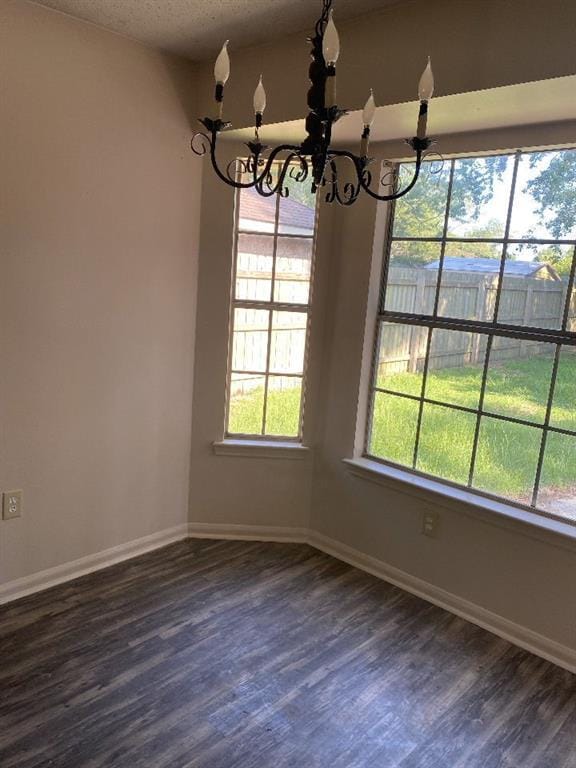 1411 Patriot St, Slidell, LA 70458 - unfurnished dining area with a chandelier, dark wood-style flooring, and a textured ceiling
