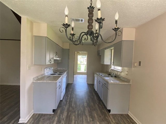 1411 Patriot St, Slidell, LA 70458 - kitchen with white range with electric cooktop, a textured ceiling, dark wood-style flooring, a chandelier, and light countertops