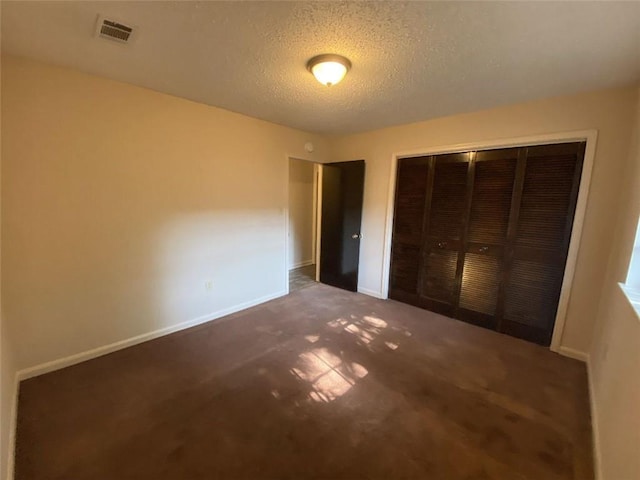 1411 Patriot St, Slidell, LA 70458 - unfurnished bedroom featuring carpet flooring, a textured ceiling, and a closet