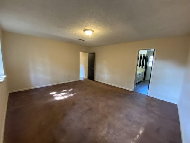 1411 Patriot St, Slidell, LA 70458 - carpeted spare room with baseboards and a textured ceiling