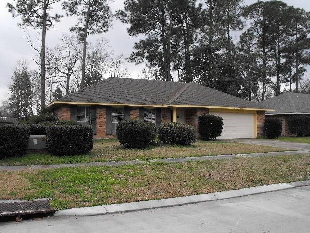 1411 Patriot St, Slidell, LA 70458 - ranch-style home featuring asphalt driveway, brick siding, a garage, and a front yard