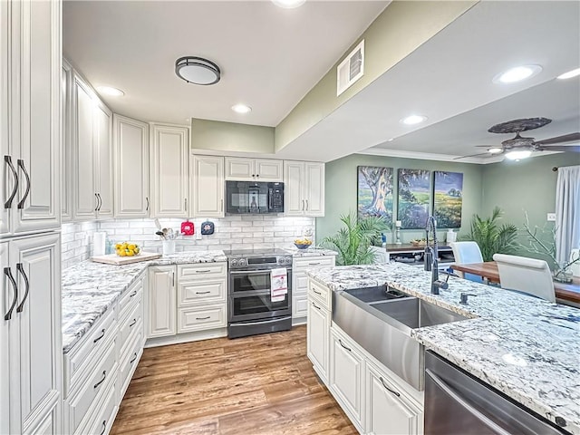 60 Chamale Cv Unit 60, Slidell, LA 70460 - kitchen with appliances with stainless steel finishes, white cabinetry, ceiling fan, decorative backsplash, and recessed lighting