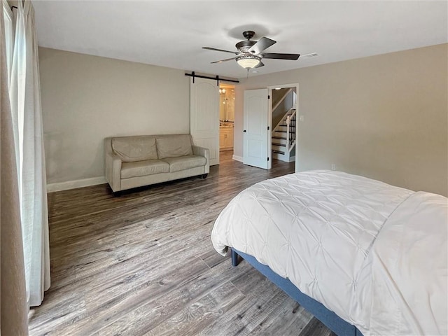 60 Chamale Cv Unit 60, Slidell, LA 70460 - bedroom featuring a barn door, wood finished floors, and ceiling fan